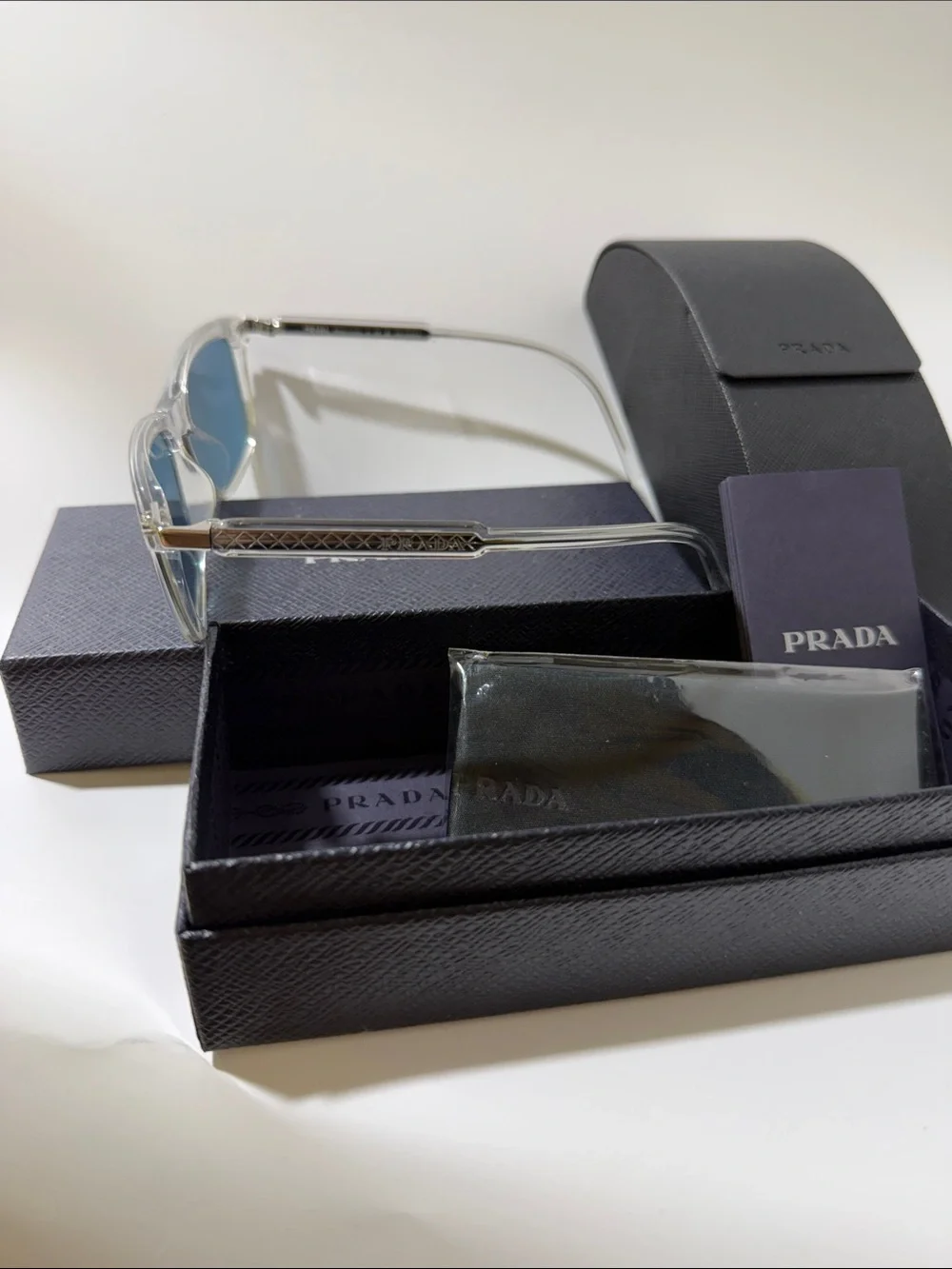Prada Clear Frame Sunglasses with Blue Lenses